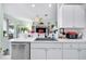 Modern kitchen with stainless steel appliances and white cabinets at 5215 New Brittany Ln, Zephyrhills, FL 33541