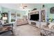 Relaxing living room with neutral tones, a large TV, and comfortable seating at 5215 New Brittany Ln, Zephyrhills, FL 33541