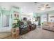 Open living room with comfortable seating and views into the kitchen at 5215 New Brittany Ln, Zephyrhills, FL 33541