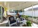 Screened porch with comfy seating and string lights at 5215 New Brittany Ln, Zephyrhills, FL 33541
