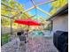 Screened pool and patio area with lounge chairs and grill at 524 Suwanee Cir, Tampa, FL 33606