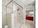 Walk-in shower with glass enclosure and adjacent bedroom view at 5301 Gulf Blvd # E202, St Pete Beach, FL 33706