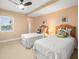 Twin bedroom with window and ceiling fan at 5301 Gulf Blvd # E202, St Pete Beach, FL 33706