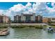 Waterfront building with private boat docks and lush landscaping at 5301 Gulf Blvd # E202, St Pete Beach, FL 33706