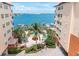Courtyard with pool, patio furniture, and gated access at 5301 Gulf Blvd # E202, St Pete Beach, FL 33706