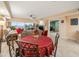 Elegant dining area with round table and red tablecloth at 5301 Gulf Blvd # E202, St Pete Beach, FL 33706