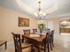 Bright dining room with a large wood table and chandelier at 5301 Gulf Blvd # E202, St Pete Beach, FL 33706