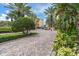 Gated community entrance with lush landscaping at 5301 Gulf Blvd # E202, St Pete Beach, FL 33706