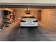 Spacious garage with car, shelving and extra storage space at 5301 Gulf Blvd # E202, St Pete Beach, FL 33706