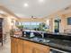 Kitchen with granite countertops, stainless steel appliances, and water views at 5301 Gulf Blvd # E202, St Pete Beach, FL 33706