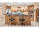 Modern kitchen with light wood cabinets and granite counters at 5301 Gulf Blvd # E202, St Pete Beach, FL 33706