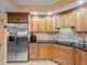 Modern kitchen featuring stainless steel refrigerator and ample cabinetry at 5301 Gulf Blvd # E202, St Pete Beach, FL 33706