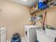 Laundry room with washer, dryer, and utility sink at 5301 Gulf Blvd # E202, St Pete Beach, FL 33706