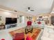 Spacious living room with comfy seating and large TV at 5301 Gulf Blvd # E202, St Pete Beach, FL 33706