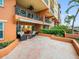 Outdoor patio with seating area, adjacent to building at 5301 Gulf Blvd # E202, St Pete Beach, FL 33706