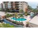 Resort-style pool with ample lounge chairs and patio umbrellas at 5301 Gulf Blvd # E202, St Pete Beach, FL 33706