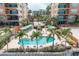 Community pool with patio, lounge chairs, and lush landscaping at 5301 Gulf Blvd # E202, St Pete Beach, FL 33706