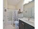 Clean bathroom featuring a bathtub, toilet and vanity with dark brown cabinets at 5608 Sunset Falls Dr, Apollo Beach, FL 33572