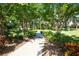 Paved pathway winds through lush landscaping, offering a tranquil community stroll at 5608 Sunset Falls Dr, Apollo Beach, FL 33572