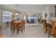 Bright dining area with wood table and chairs, opens to living room at 5608 Sunset Falls Dr, Apollo Beach, FL 33572