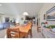 Bright dining room with wood table and chairs, view into kitchen and living areas at 5608 Sunset Falls Dr, Apollo Beach, FL 33572