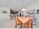 Dining room with light wood table and chairs, kitchen view at 5608 Sunset Falls Dr, Apollo Beach, FL 33572