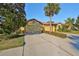 House exterior showcasing a two-car garage and manicured landscaping at 5608 Sunset Falls Dr, Apollo Beach, FL 33572