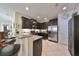 Spacious kitchen with dark wood cabinets, granite countertops, and stainless steel appliances at 5608 Sunset Falls Dr, Apollo Beach, FL 33572