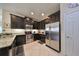 Modern kitchen with dark wood cabinets, granite countertops, and stainless steel appliances at 5608 Sunset Falls Dr, Apollo Beach, FL 33572
