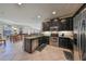 Well-equipped kitchen featuring dark wood cabinets and stainless steel appliances at 5608 Sunset Falls Dr, Apollo Beach, FL 33572