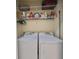 Bright laundry room with washer, dryer and ample shelving at 5608 Sunset Falls Dr, Apollo Beach, FL 33572