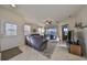 Living room with gray sectional sofa, access to backyard patio at 5608 Sunset Falls Dr, Apollo Beach, FL 33572