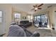 Spacious living room with gray sectional sofa and sliding glass doors to patio at 5608 Sunset Falls Dr, Apollo Beach, FL 33572