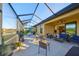 This screened patio includes a grill and outdoor furniture at 5608 Sunset Falls Dr, Apollo Beach, FL 33572