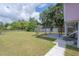 Large grassy backyard with a patio and pergola at 5901 N Cherokee Ave, Tampa, FL 33604
