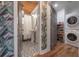 Updated bathroom with subway tile, patterned floor, and laundry area at 5901 N Cherokee Ave, Tampa, FL 33604