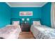 Bright bedroom with two twin beds and teal walls at 5901 N Cherokee Ave, Tampa, FL 33604