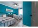 Teal bedroom with two twin beds, and a ceiling fan at 5901 N Cherokee Ave, Tampa, FL 33604