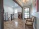Bright entryway with wood floors, built-in shelving, and French doors leading outside at 5901 N Cherokee Ave, Tampa, FL 33604
