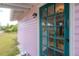 Charming pink house with a teal door and well-manicured lawn at 5901 N Cherokee Ave, Tampa, FL 33604