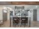 Modern kitchen with island, stainless steel appliances, and wood beams at 5901 N Cherokee Ave, Tampa, FL 33604