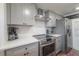 Modern kitchen with stainless steel appliances and white quartz countertops at 5901 N Cherokee Ave, Tampa, FL 33604