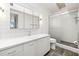 Modern bathroom with white tile, floating vanity, and large shower at 6 Treasure Ln, Treasure Island, FL 33706