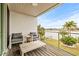 Waterfront deck with wooden flooring and comfortable seating at 6 Treasure Ln, Treasure Island, FL 33706