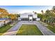 Modern waterfront home with clean lines and palm trees at 6 Treasure Ln, Treasure Island, FL 33706