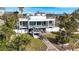 Back view of contemporary home, showcasing patio and landscaping at 6 Treasure Ln, Treasure Island, FL 33706