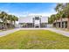 Modern two-story home with a carport and manicured lawn at 6 Treasure Ln, Treasure Island, FL 33706