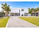 Contemporary house with driveway, landscaping, and boat parking at 6 Treasure Ln, Treasure Island, FL 33706