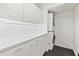 Bright laundry room with stacked washer and dryer at 6 Treasure Ln, Treasure Island, FL 33706