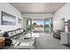 Modern living room with water views and sliding glass doors at 6 Treasure Ln, Treasure Island, FL 33706